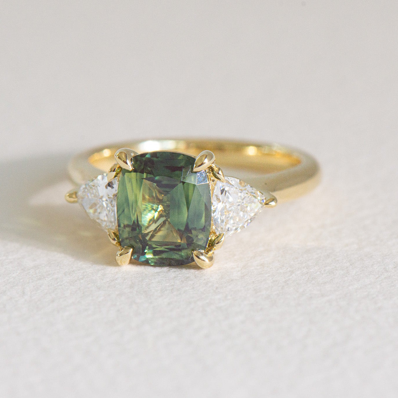 Cushion-cut Australian parti sapphire engagement ring with a 2.61ct natural sapphire, lab-grown diamond, 18k yellow gold cathedral setting.