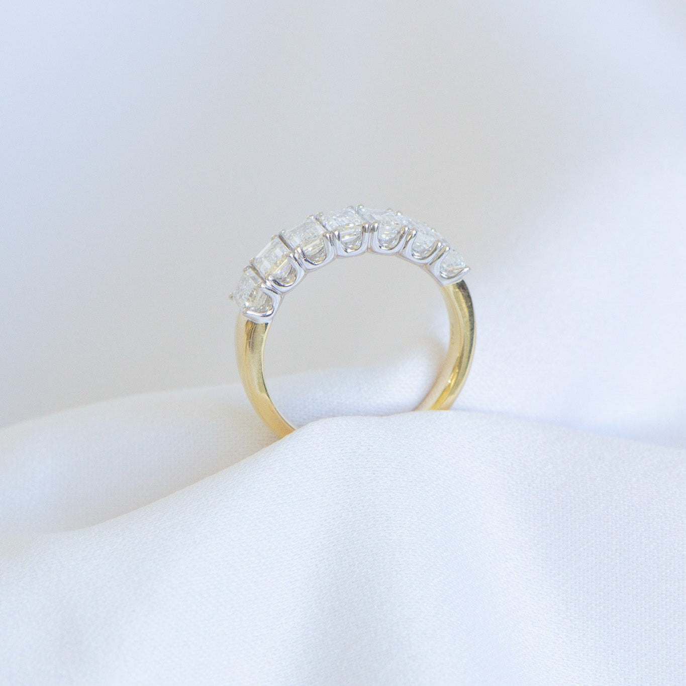 Estelle medium wedding ring crafted in 18K gold with 7 emerald cut lab-grown diamonds