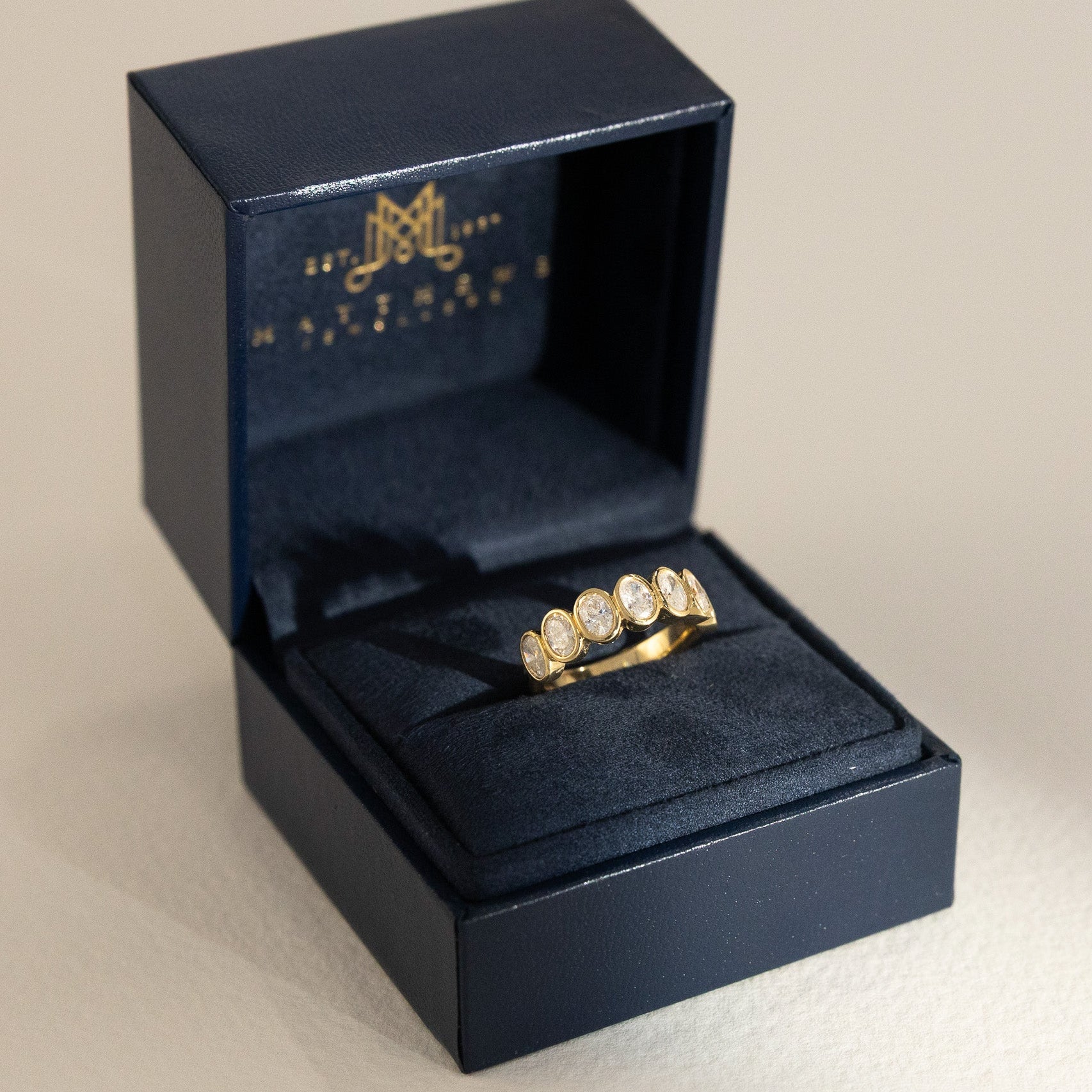 Amari oval diamond wedding ring in 18K gold with 7 lab-grown diamonds by Matthews Jewellers Newcastle