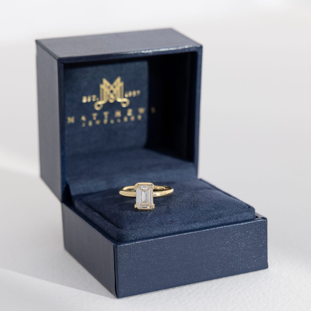 Half Bezel Edith | Emerald Diamond Engagement Ring