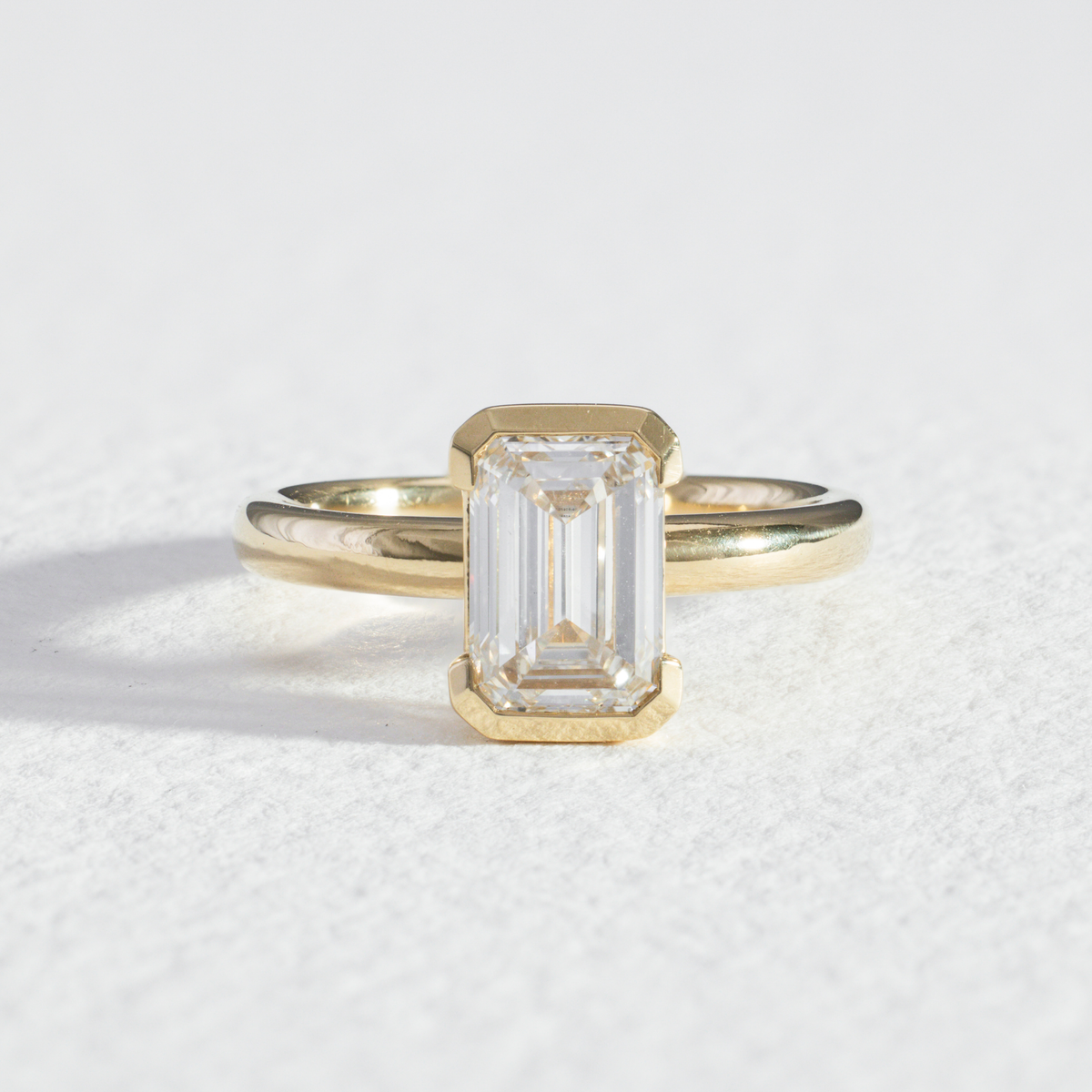 Half Bezel Edith | Emerald Diamond Engagement Ring