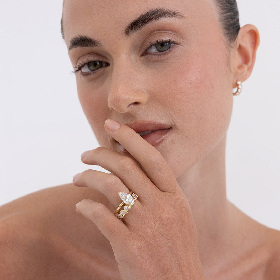 Ada pear diamond wedding band in 18K gold featuring a bezel-set east west design