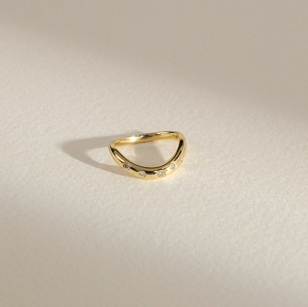 Issy curved diamond wedding band in 18K gold, handcrafted by Matthews Jewellers Newcastle
