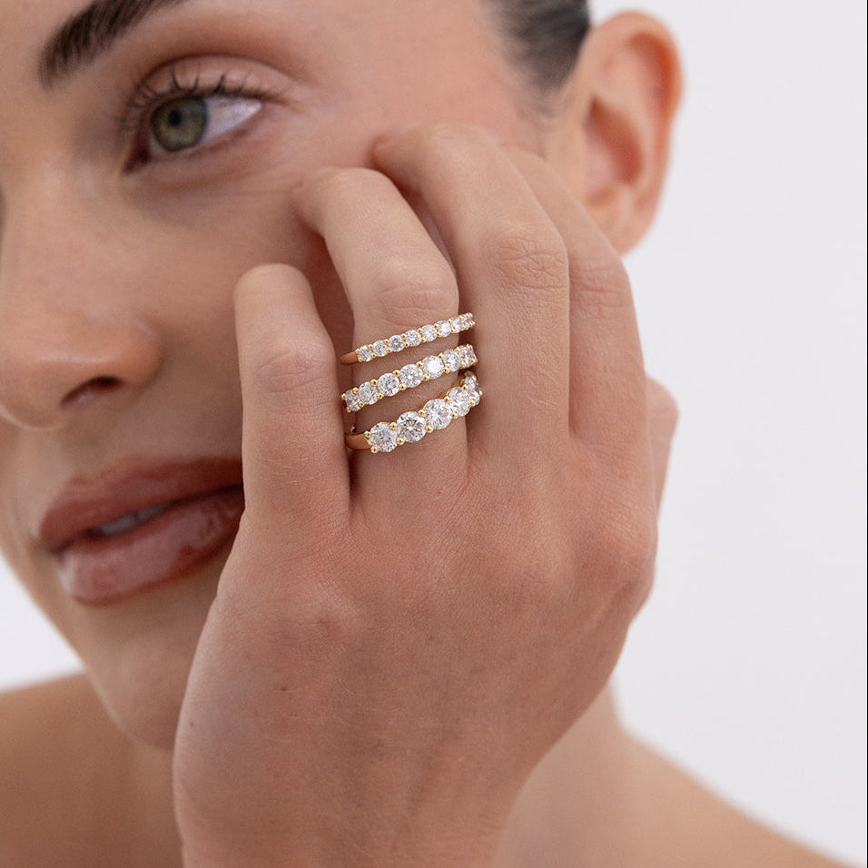 Jana round diamond wedding band in 18K yellow gold featuring shared claw-set diamonds