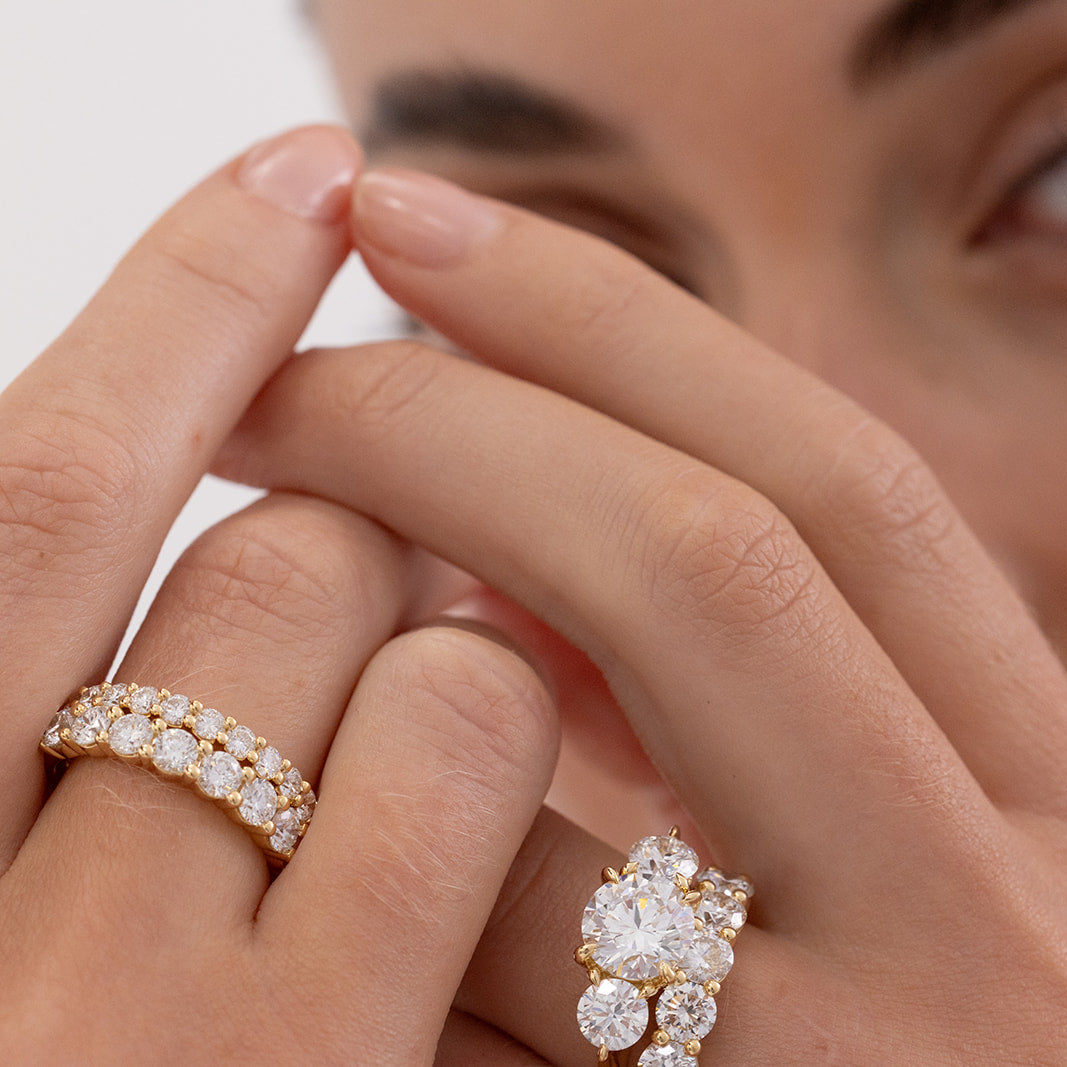 Jana round brilliant diamond wedding band crafted in 18K gold with a shared claw setting