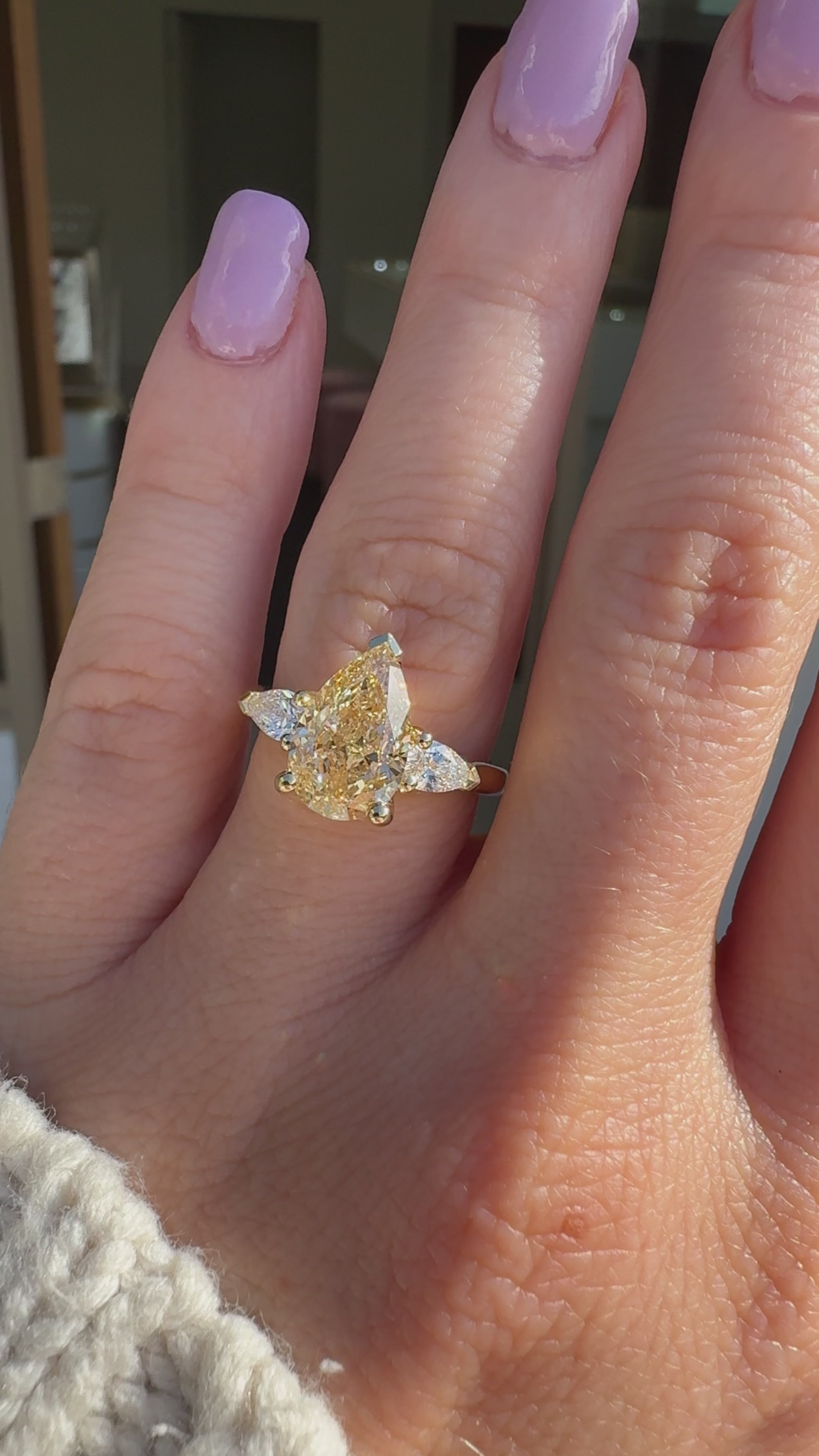 Video on hand of Solenne 3ct fancy yellow pear lab grown three stone diamond engagement ring in 18k yellow gold, handcrafted by Matthews Jewellers